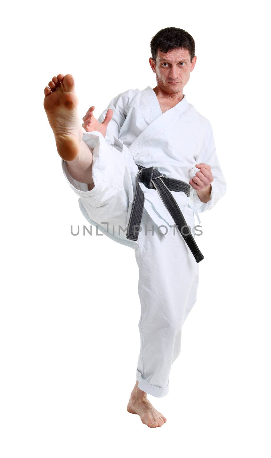 Karate. Man in a kimono hits foot by aptyp_kok