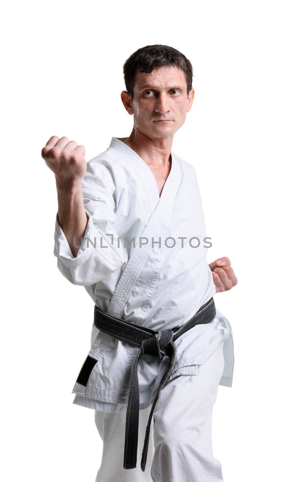Karate. Man in a kimono with a white background
