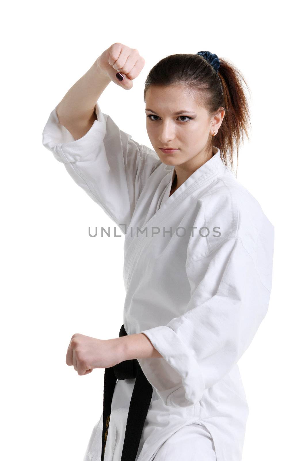 Karate. Young girl in a kimono with a white background
