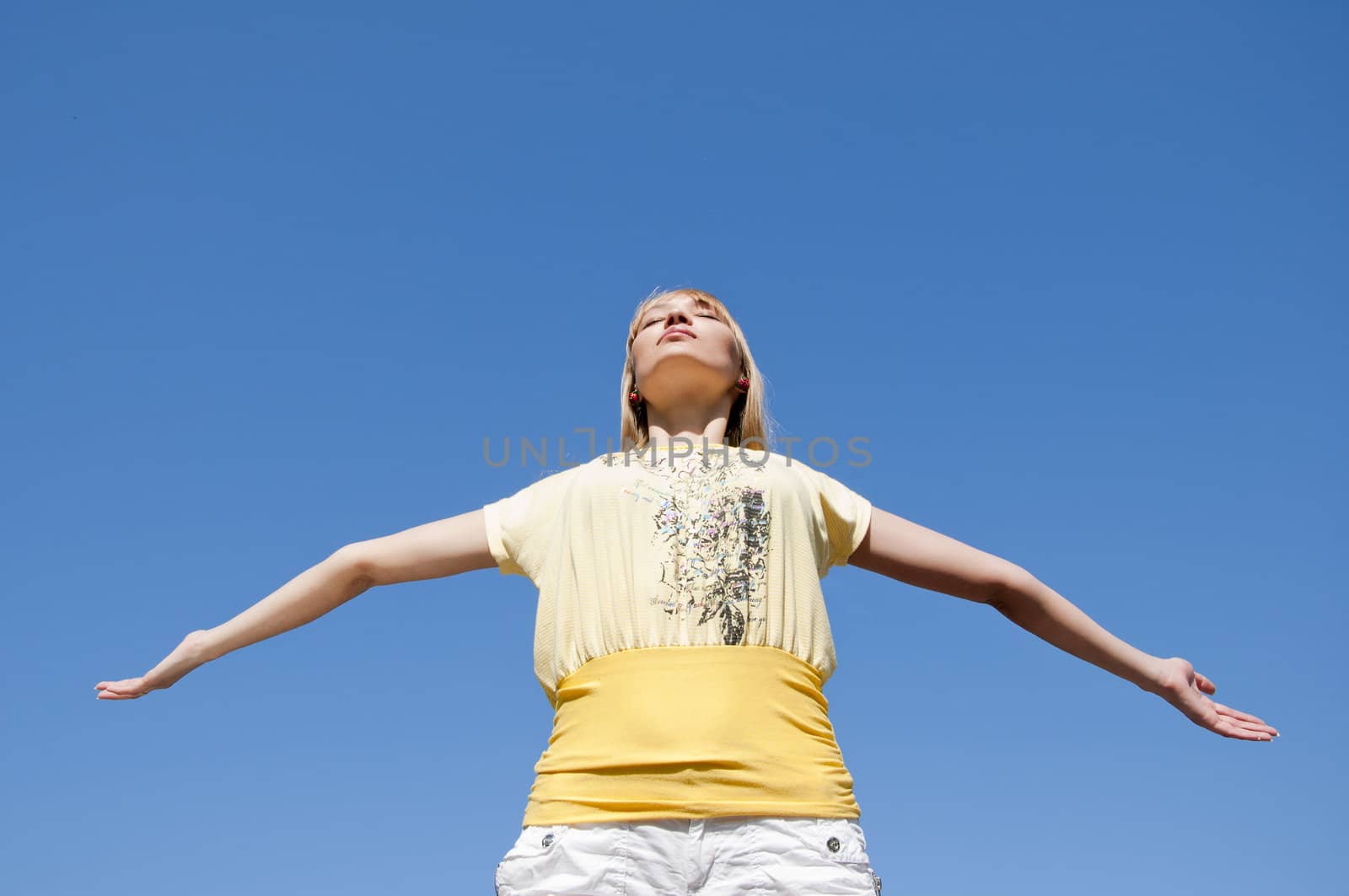 woman having stretched hands aspires in the sky by adam121