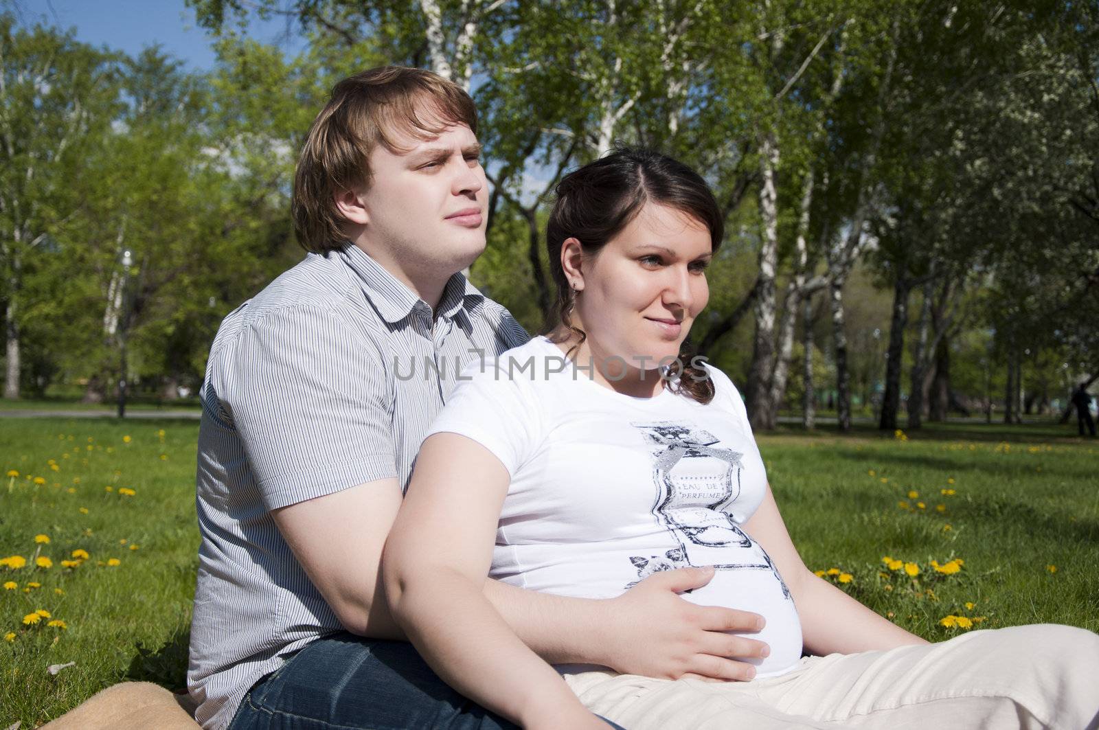 man and pregnant woman in the park by adam121