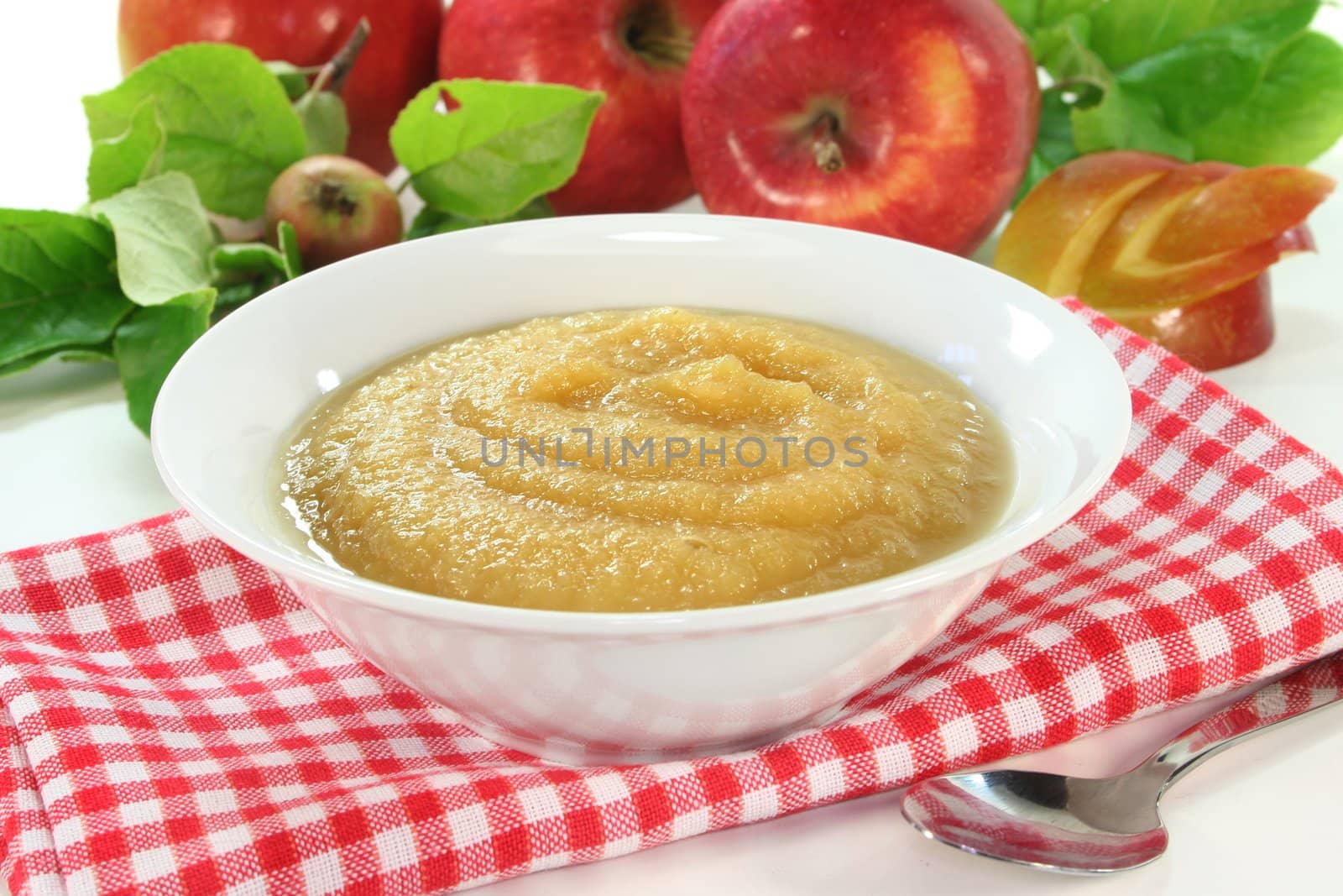 a white bowl with fresh apples and apple sauce