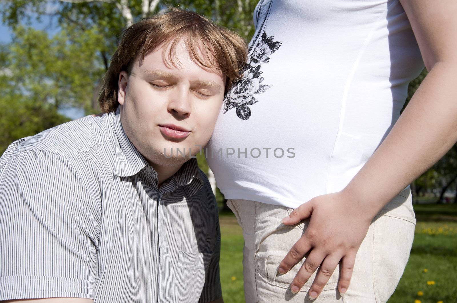 The man has put an ear to a stomach pregnancy mothers