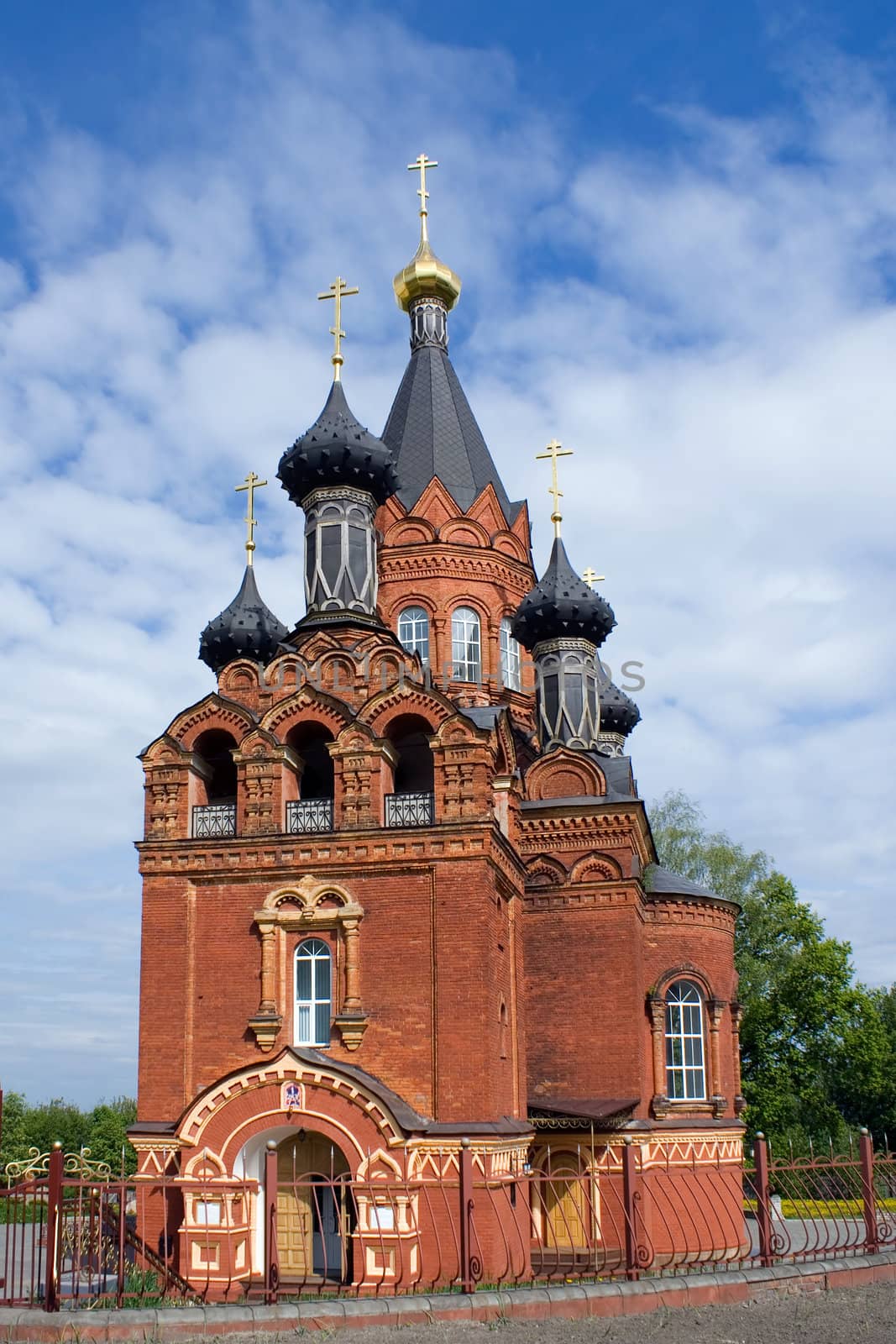 Red church with black cupolas in Bryansk, Russia