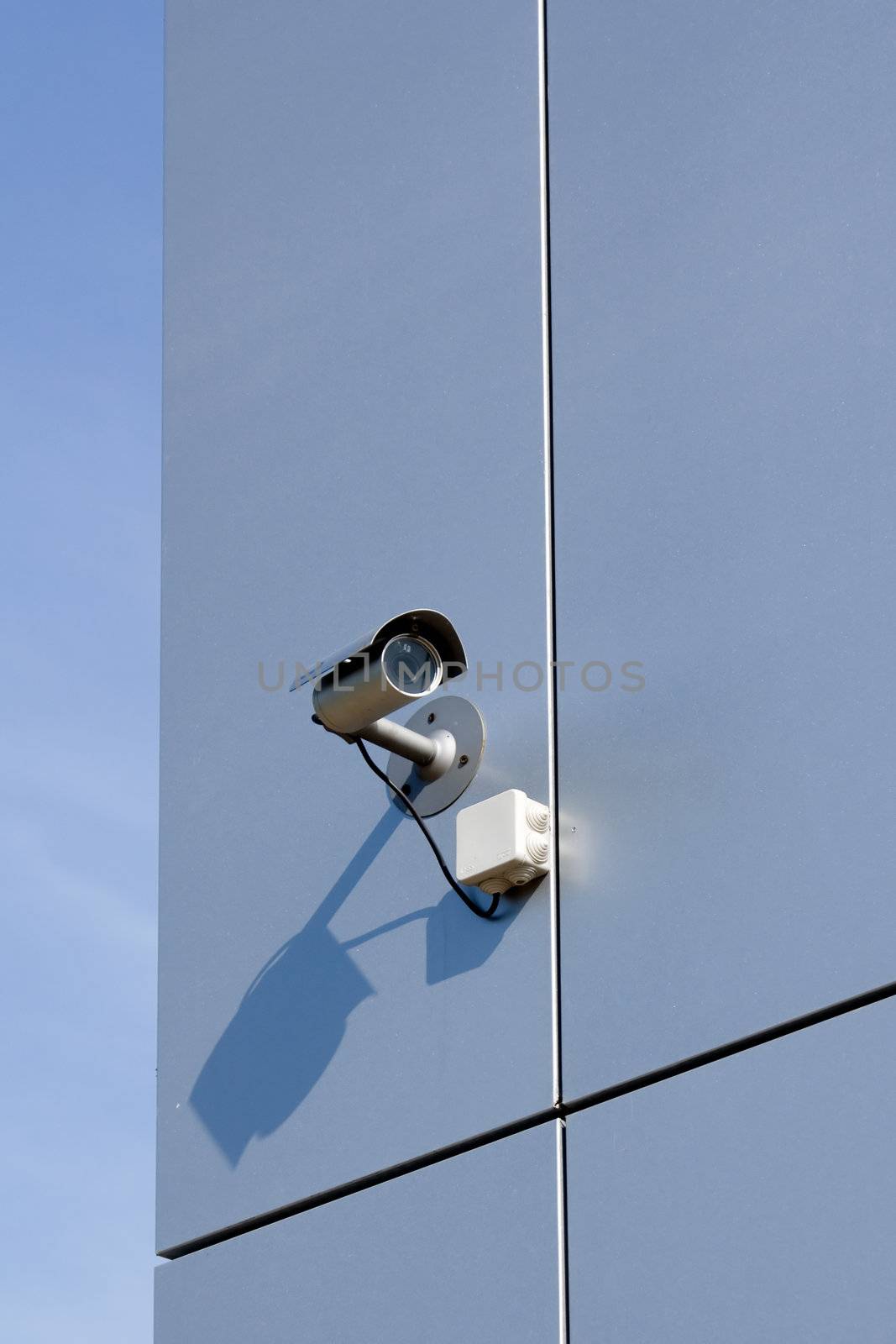 A security camera on the side of an office building.