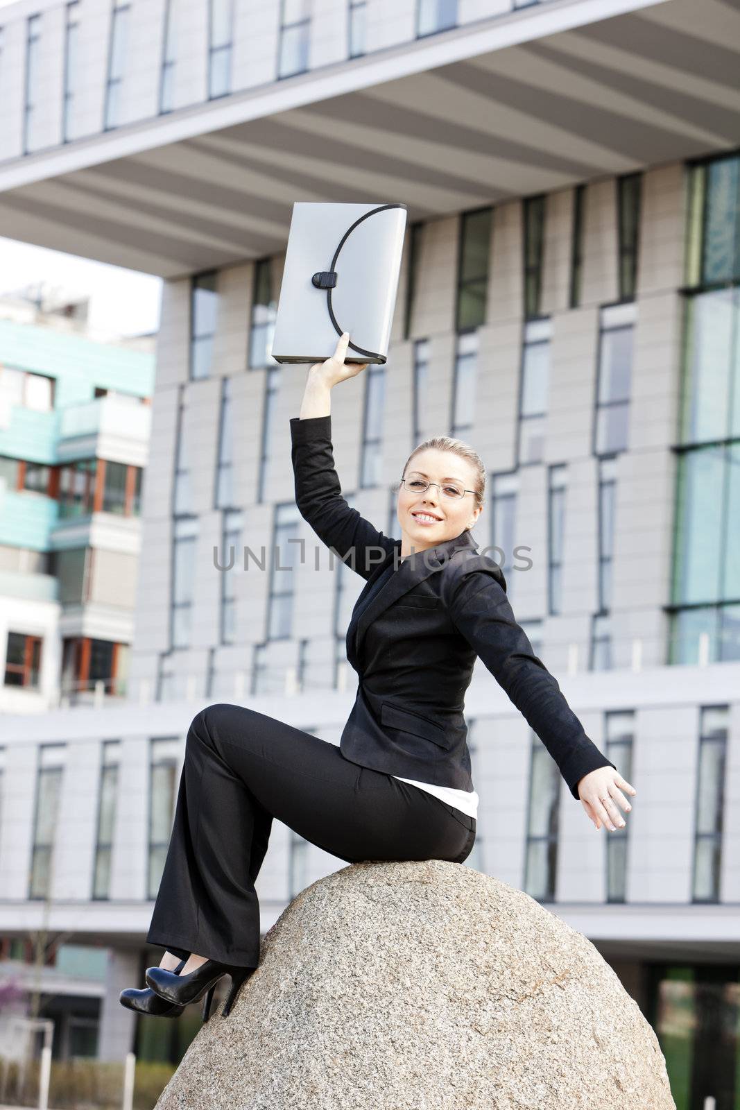 sitting young businesswoman with a briefcase