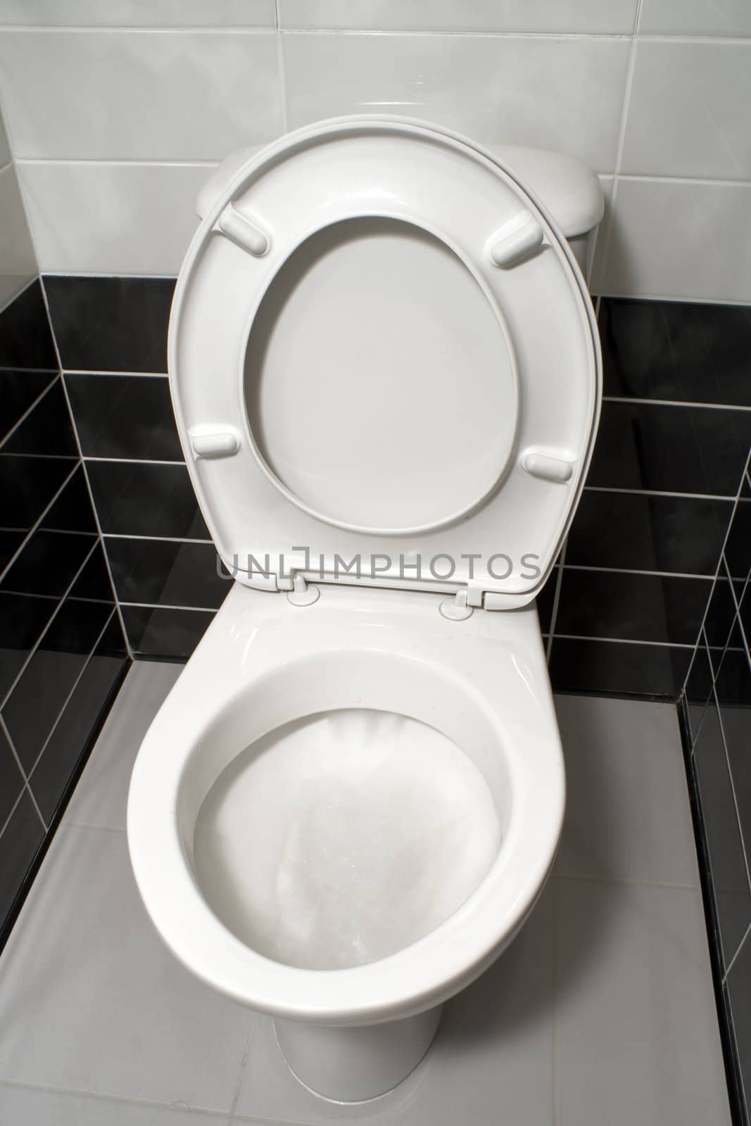 White toilet bowl with open toilet seat cover