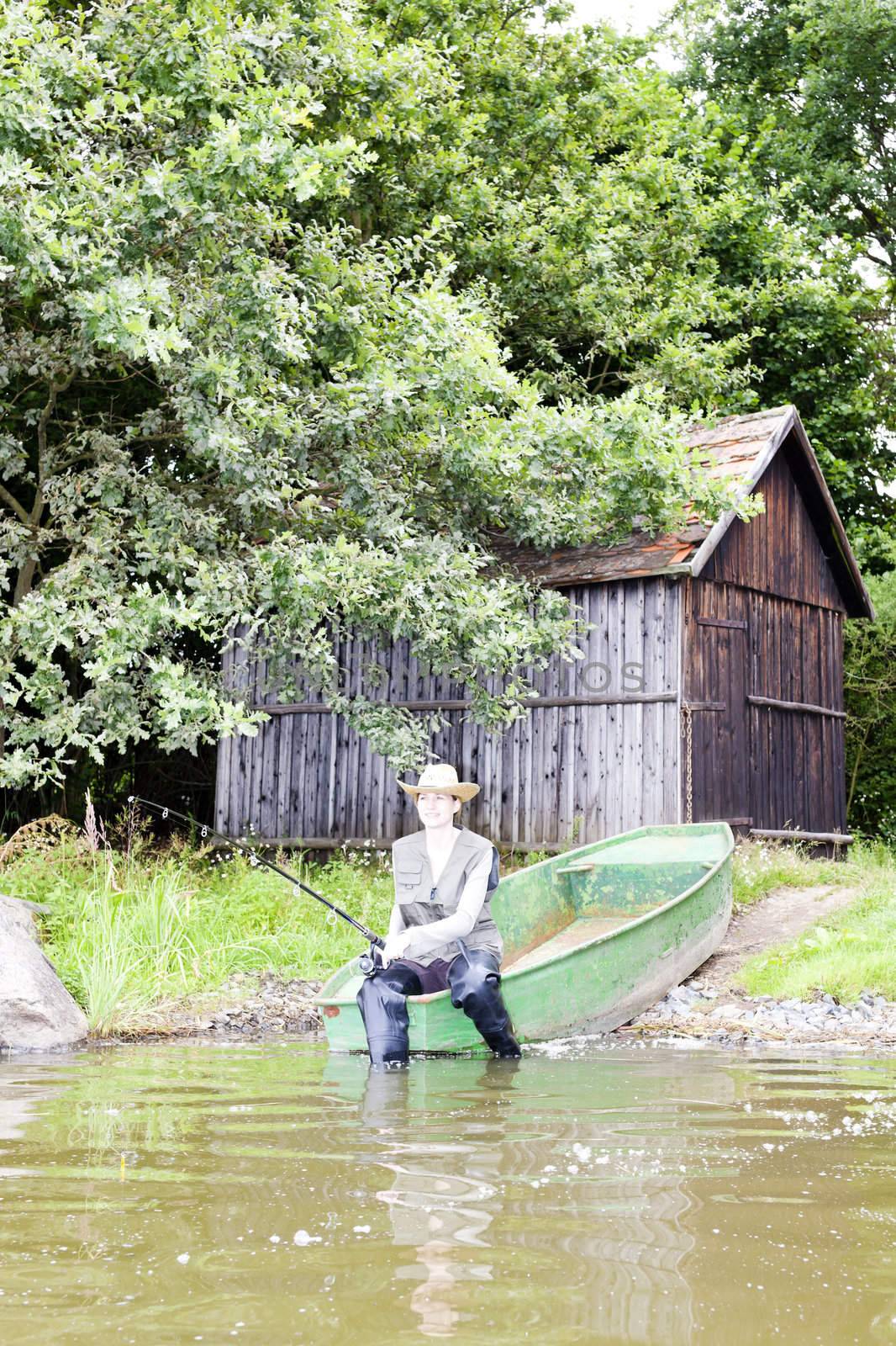 fishing woman sitting on boat by phbcz