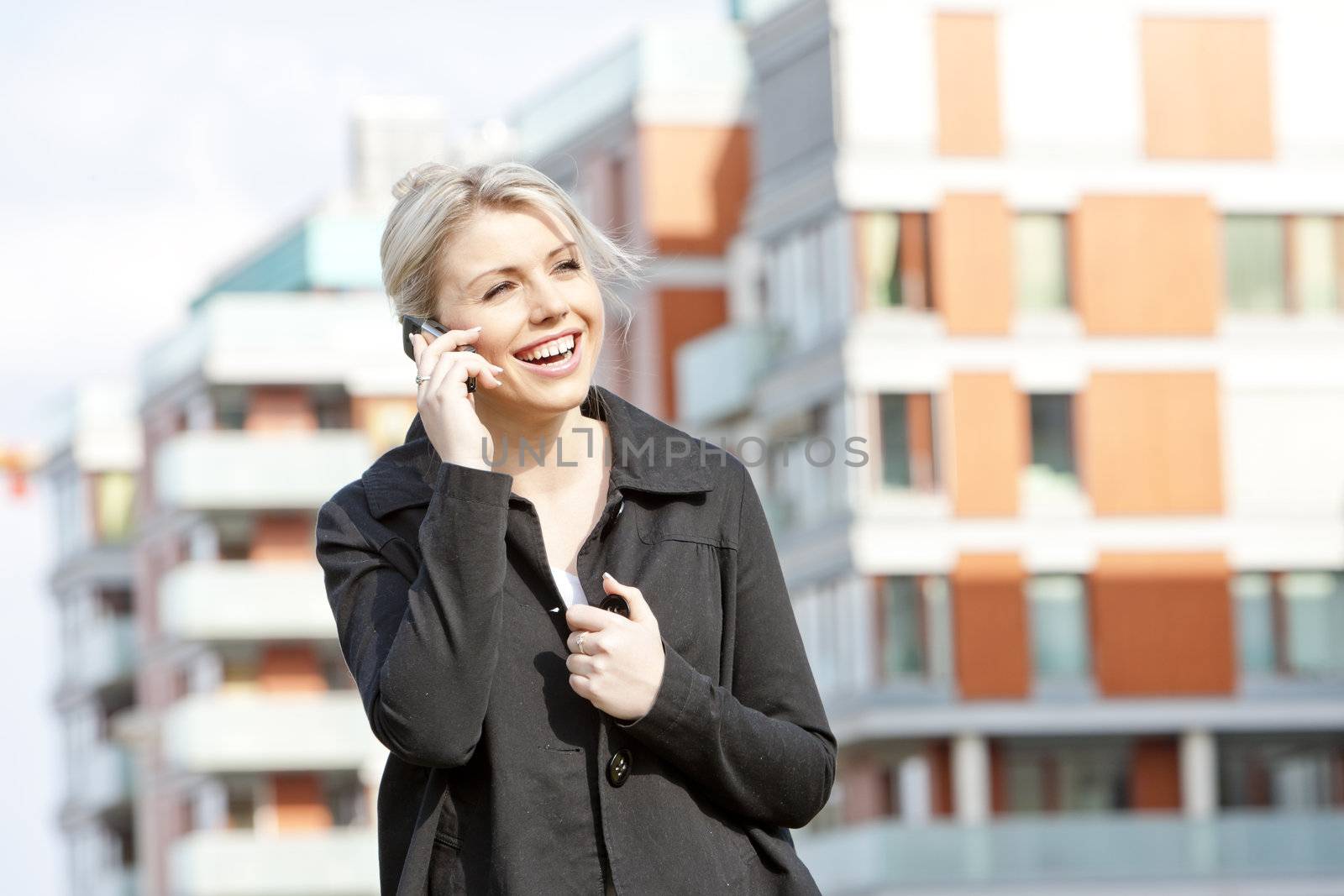 portrait of telephoning young businesswoman by phbcz