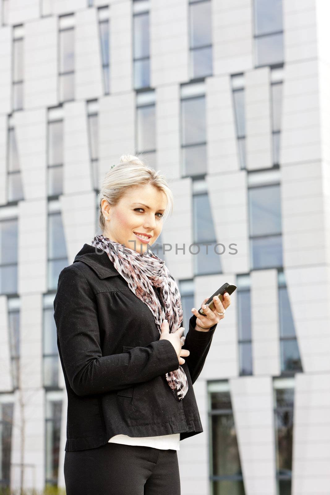 portrait of young businesswoman with a mobile by phbcz