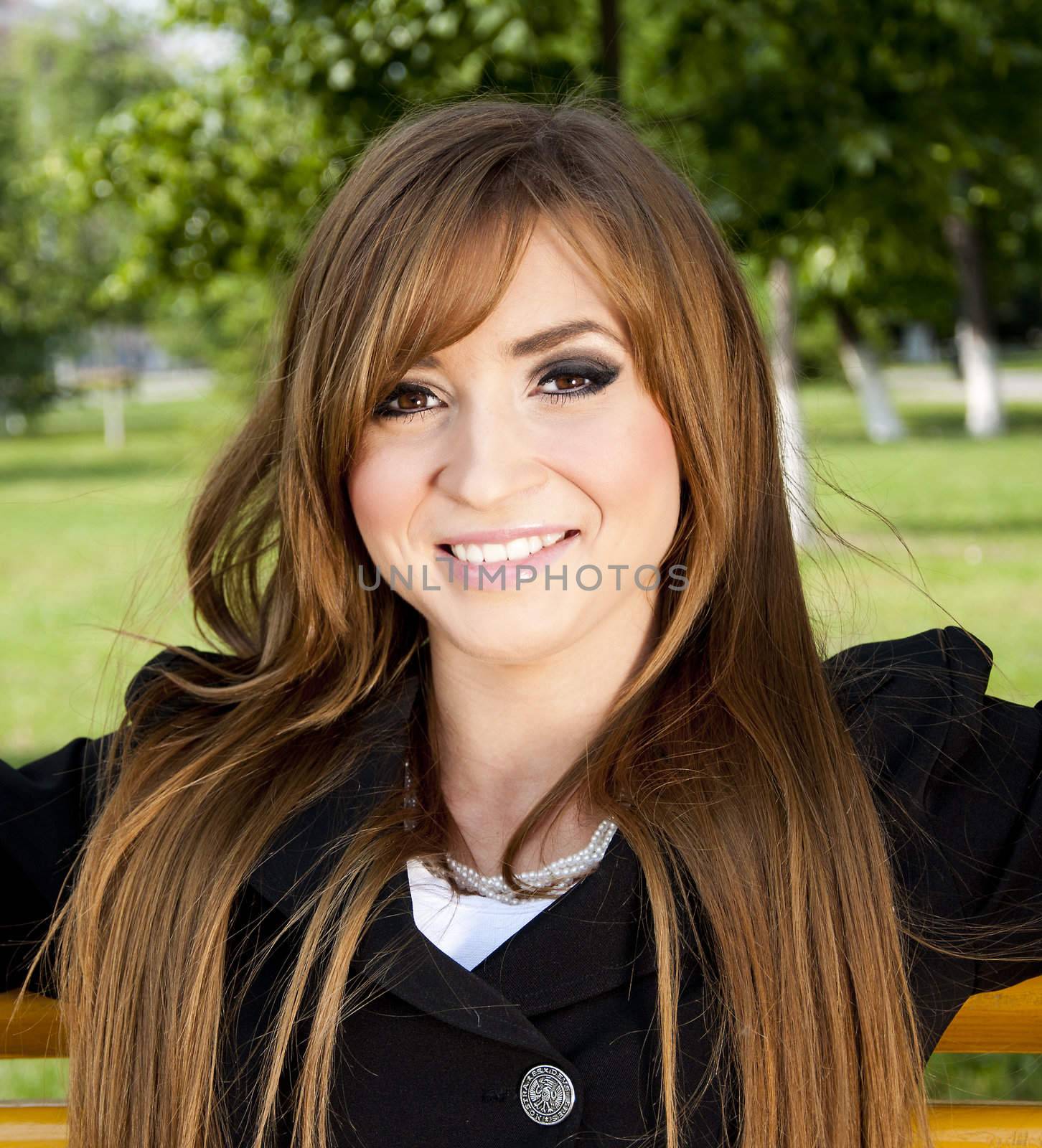 young girl sits in park on a bench by adam121