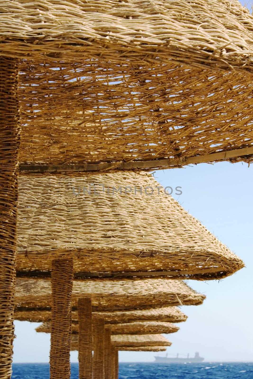 Row of an awnings and ship on horizon