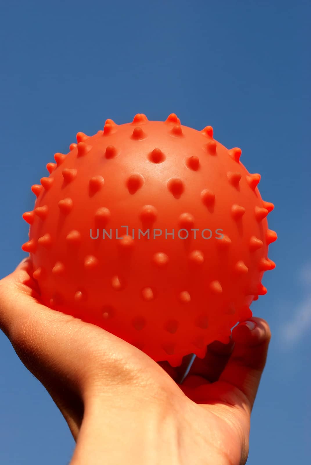 Ball in hand against the blue sky