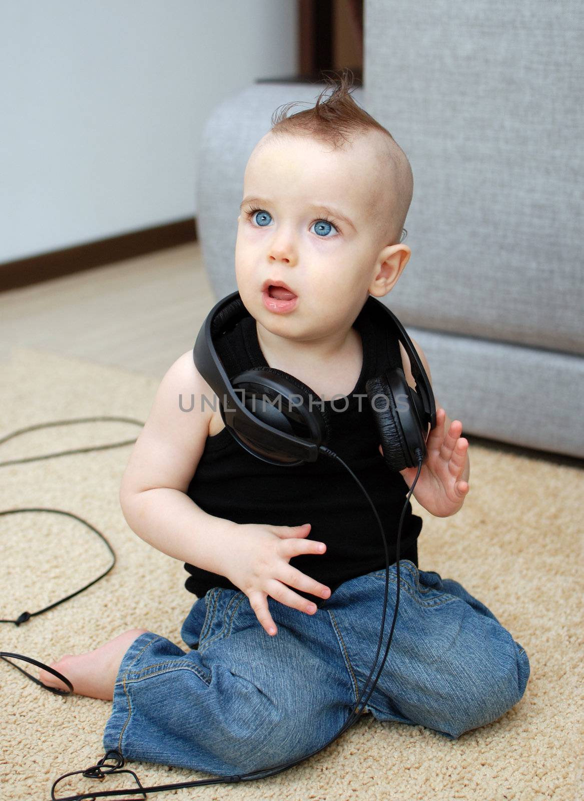 Portrait of serious baby in the earphones