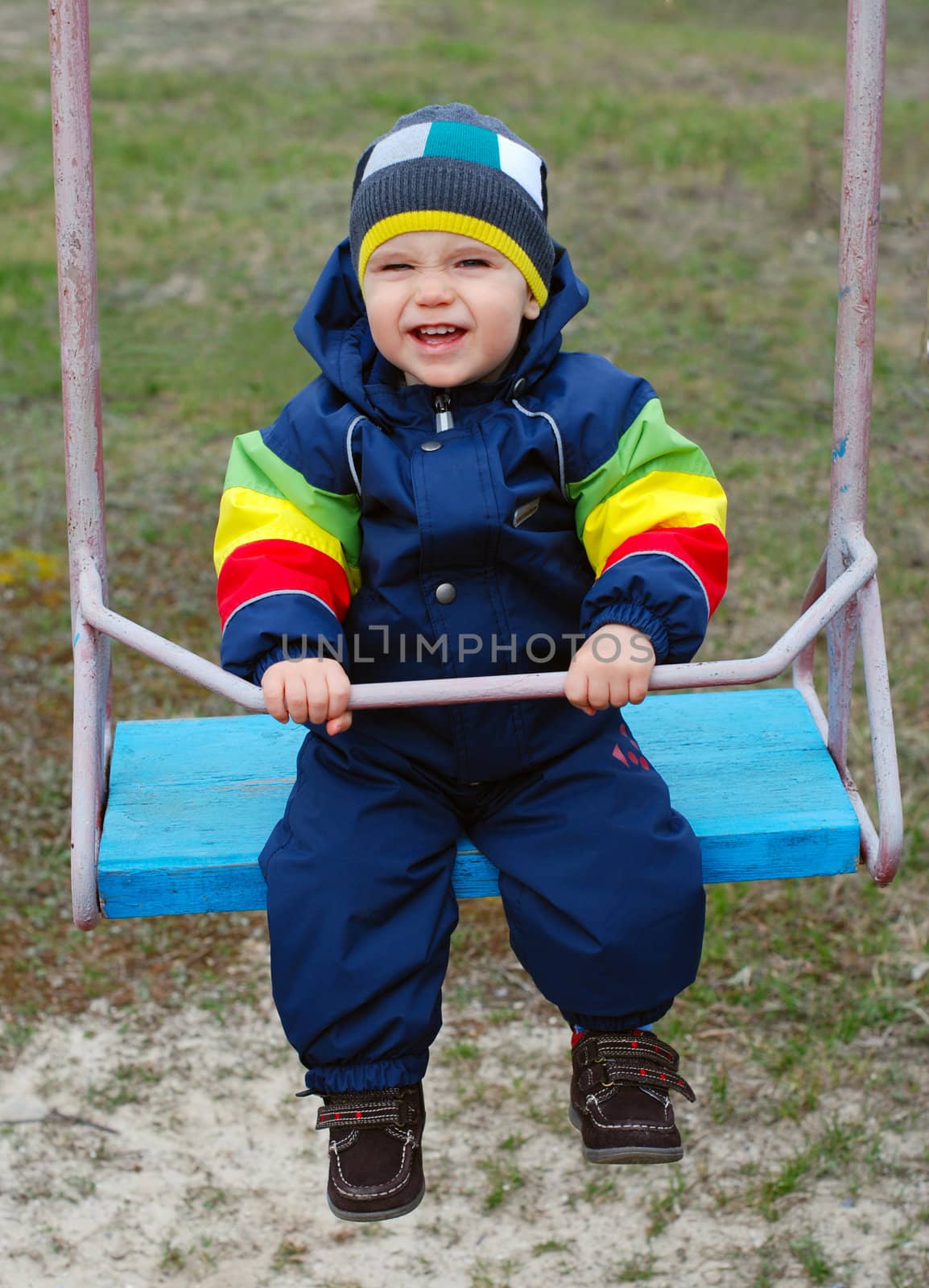 Happy little boy on swing