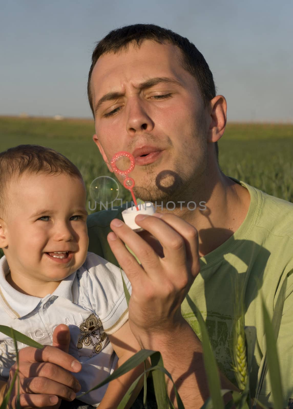 Dad and son are blowing bubbles