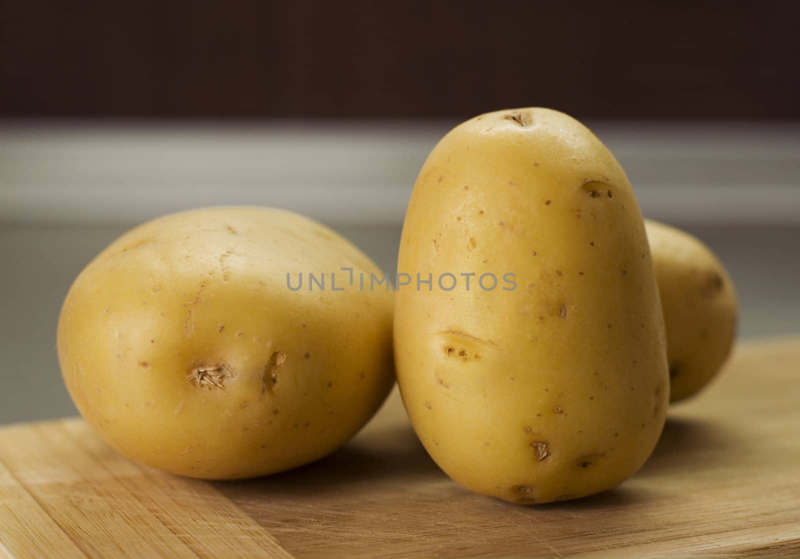 group of potatoes waiting on breadboard by kzen