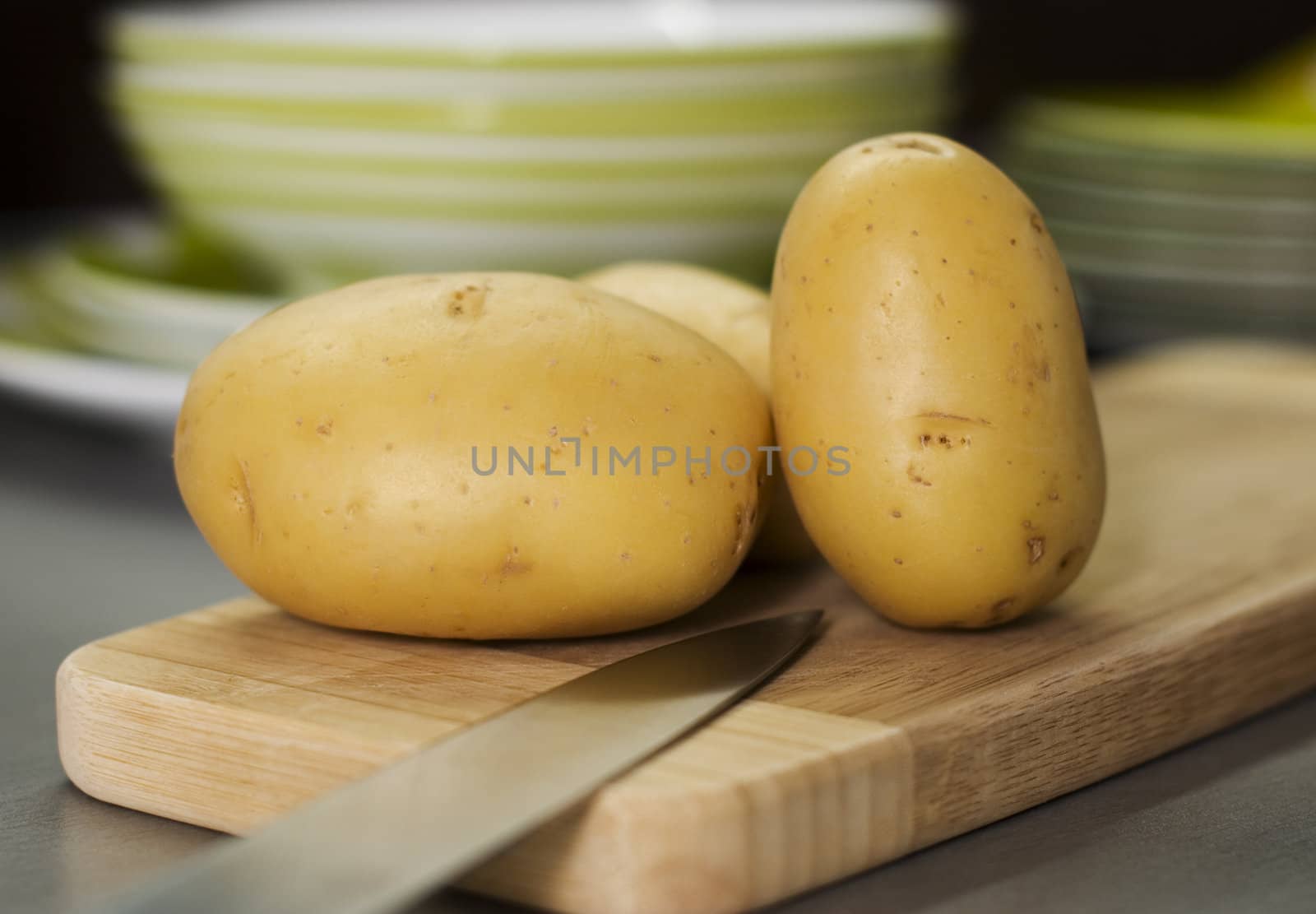 group of potatoes waiting on breadboard by kzen