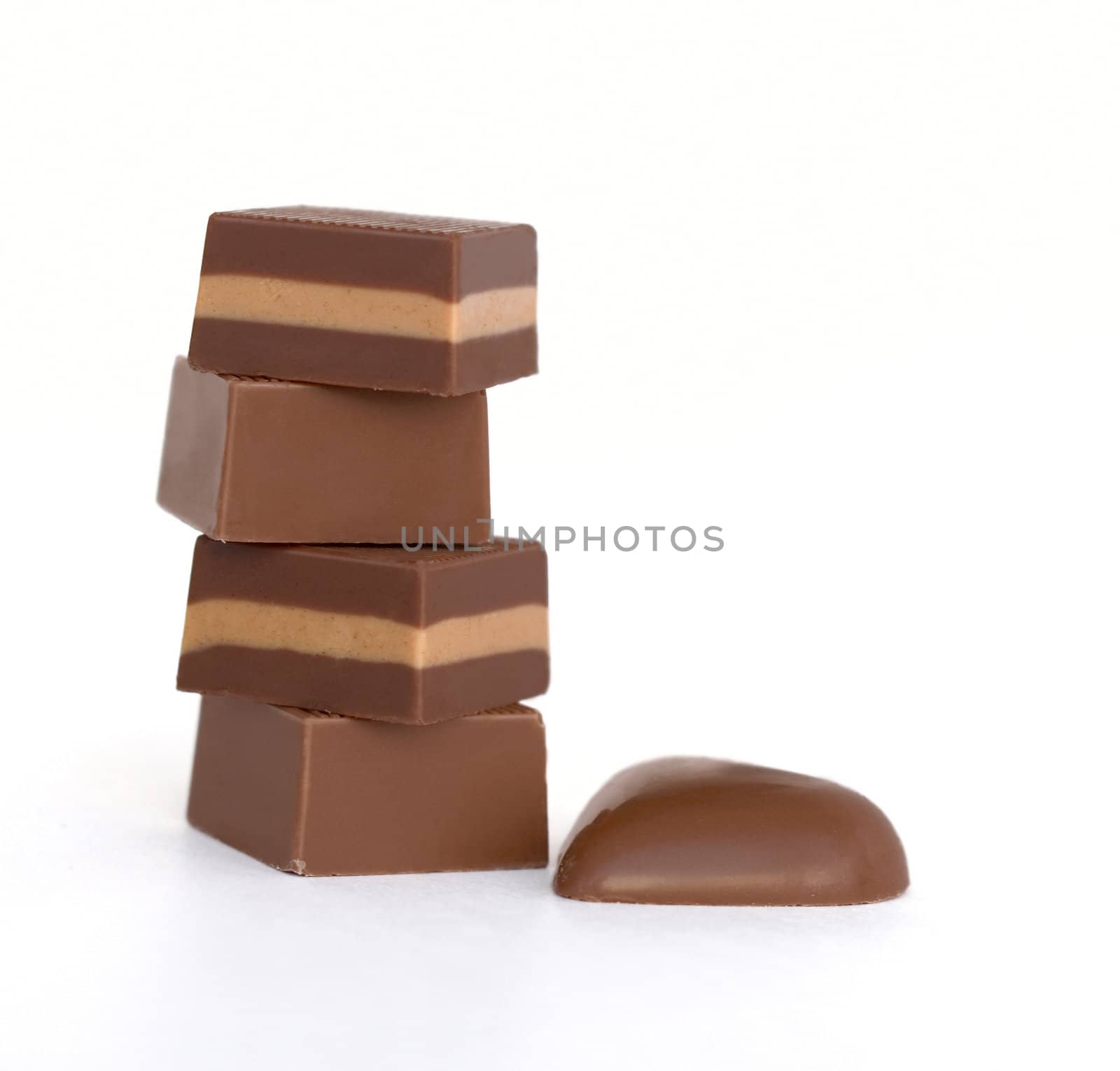 Pile of chocolates on white background