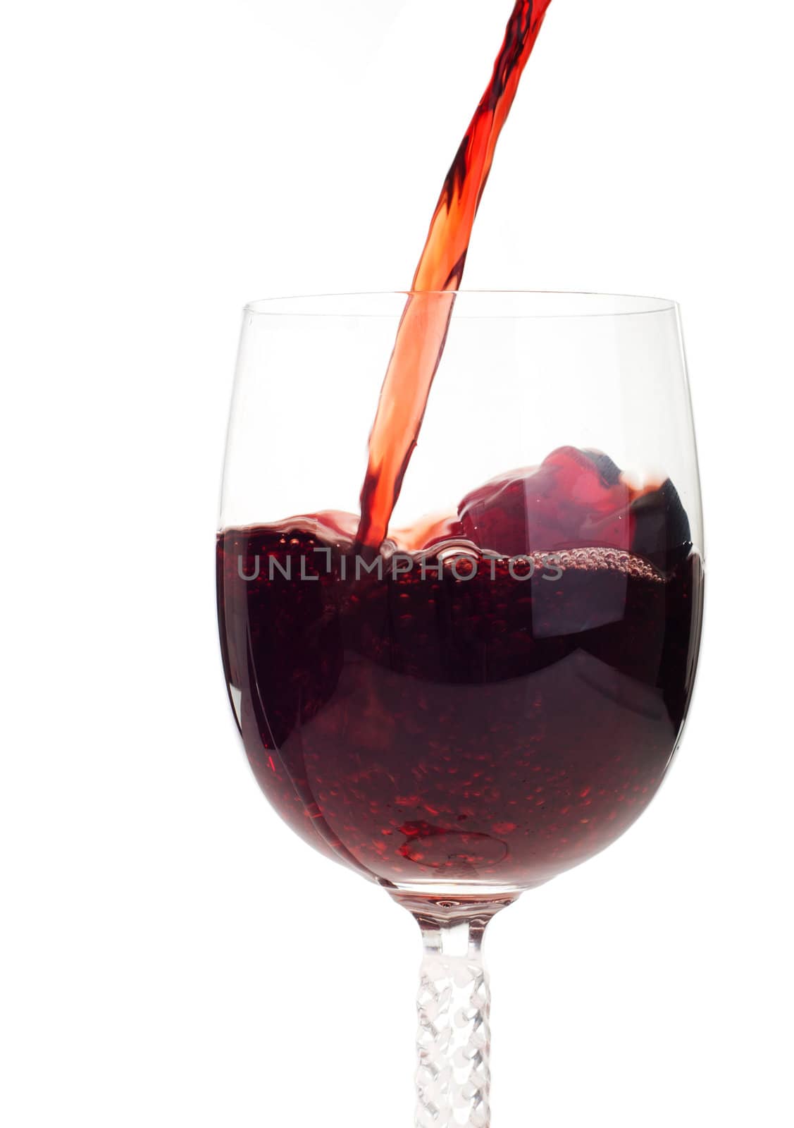 red wine pouring into a crystal glass (isolated on white background)