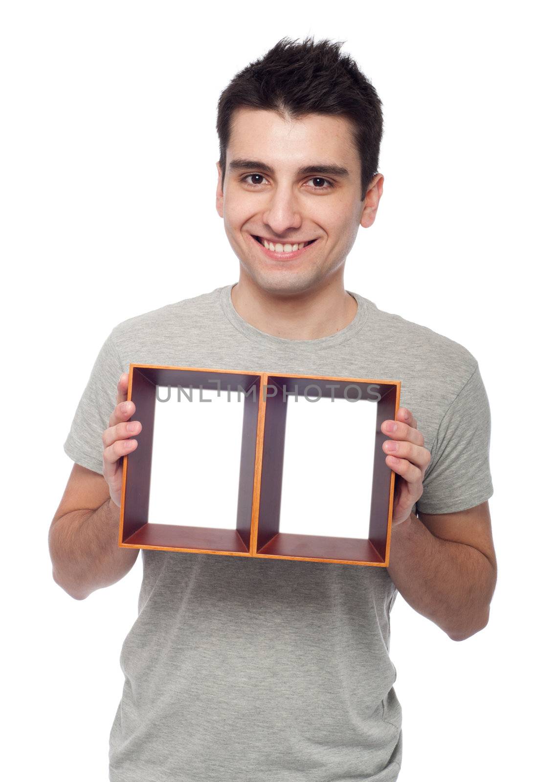 smiling young man holding empty frame isolated on white background