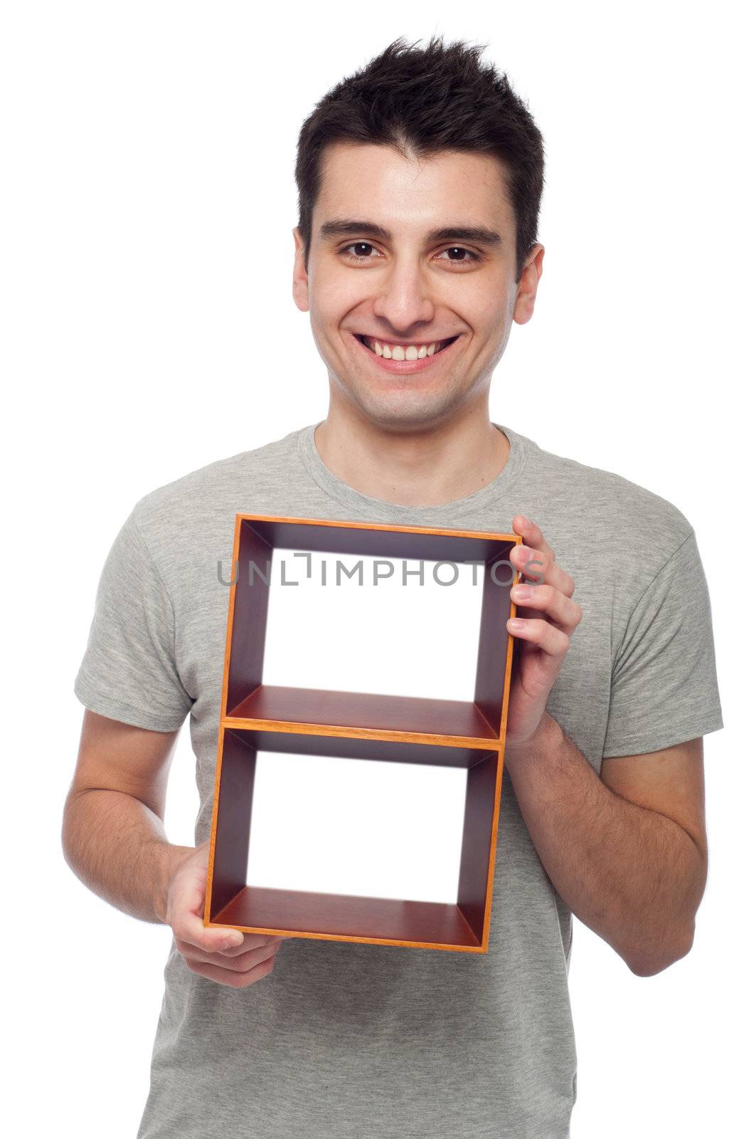 smiling young man holding empty frame isolated on white background