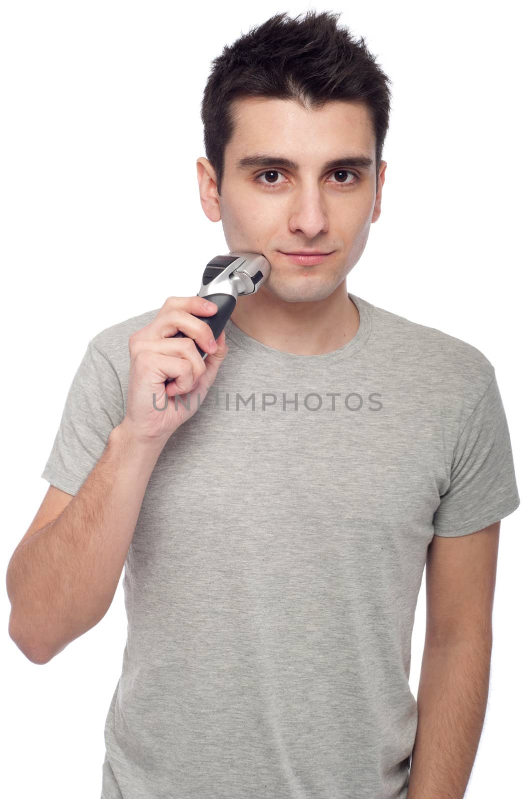 handsome young man shaving with electric shaver (isolated on white background)