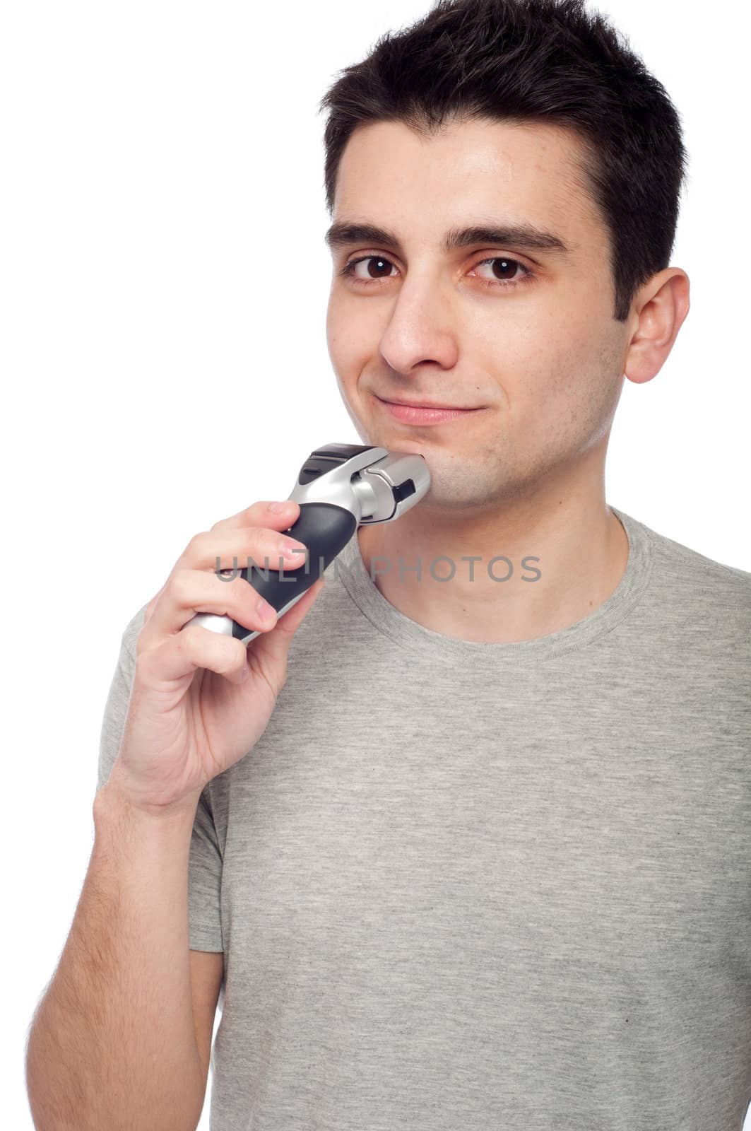handsome young man shaving with electric shaver (isolated on white background)
