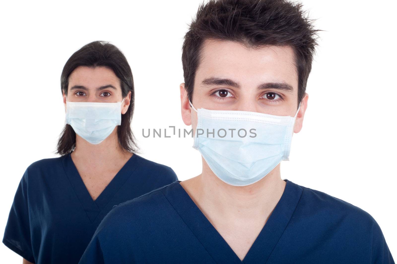 portrait of a team of doctors, man and woman wearing mask and uniform isolated on white background (focus on man)