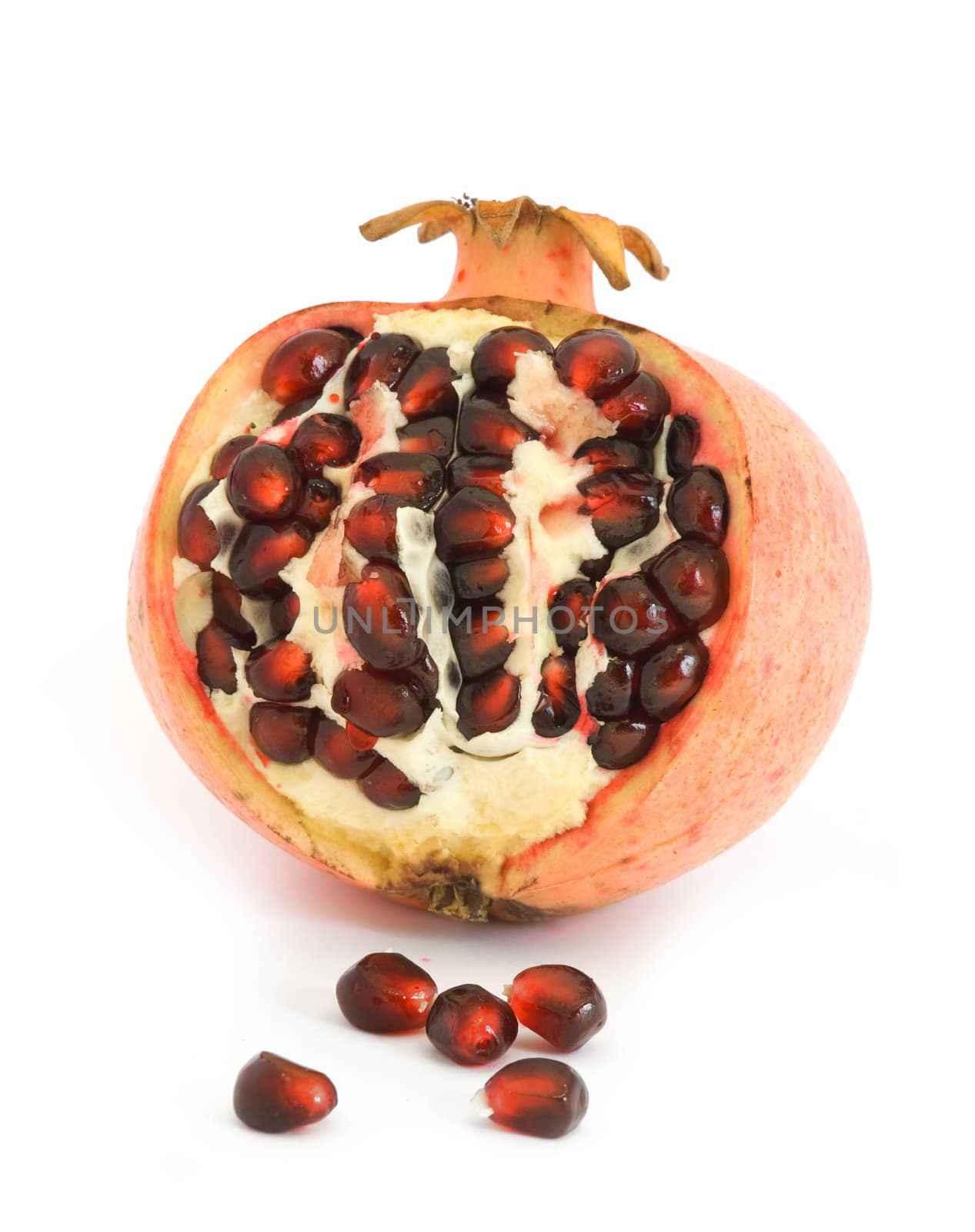 Pomegranate cut open showing seeds, isolated on white