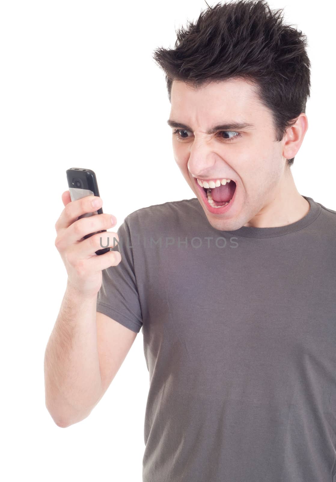 angry young man yelling at mobile phone isolated on white background