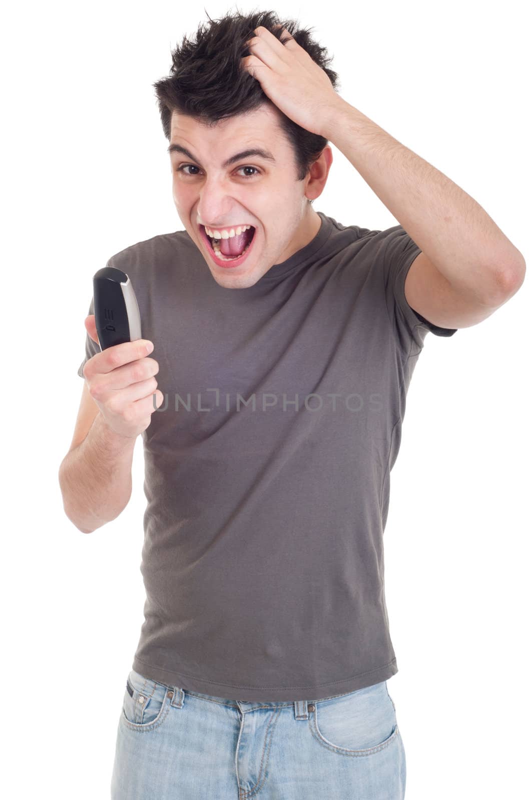 angry young man yelling at mobile phone isolated on white background