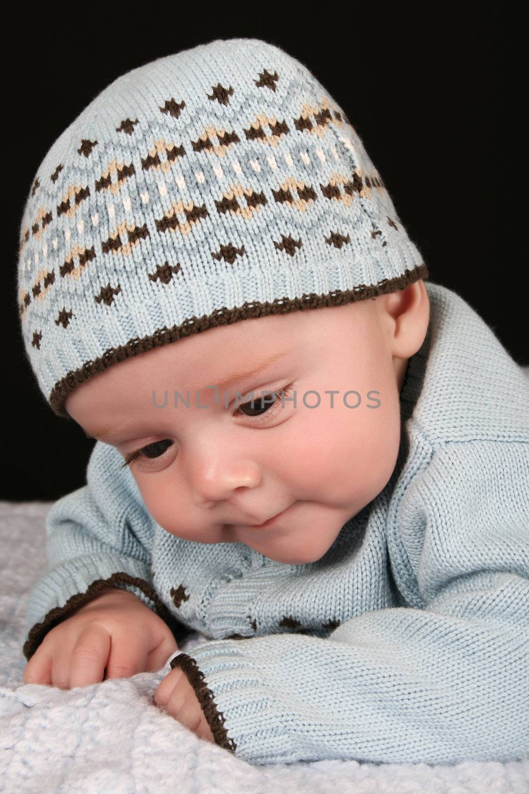 Cute four month old baby boy lying on his tummy