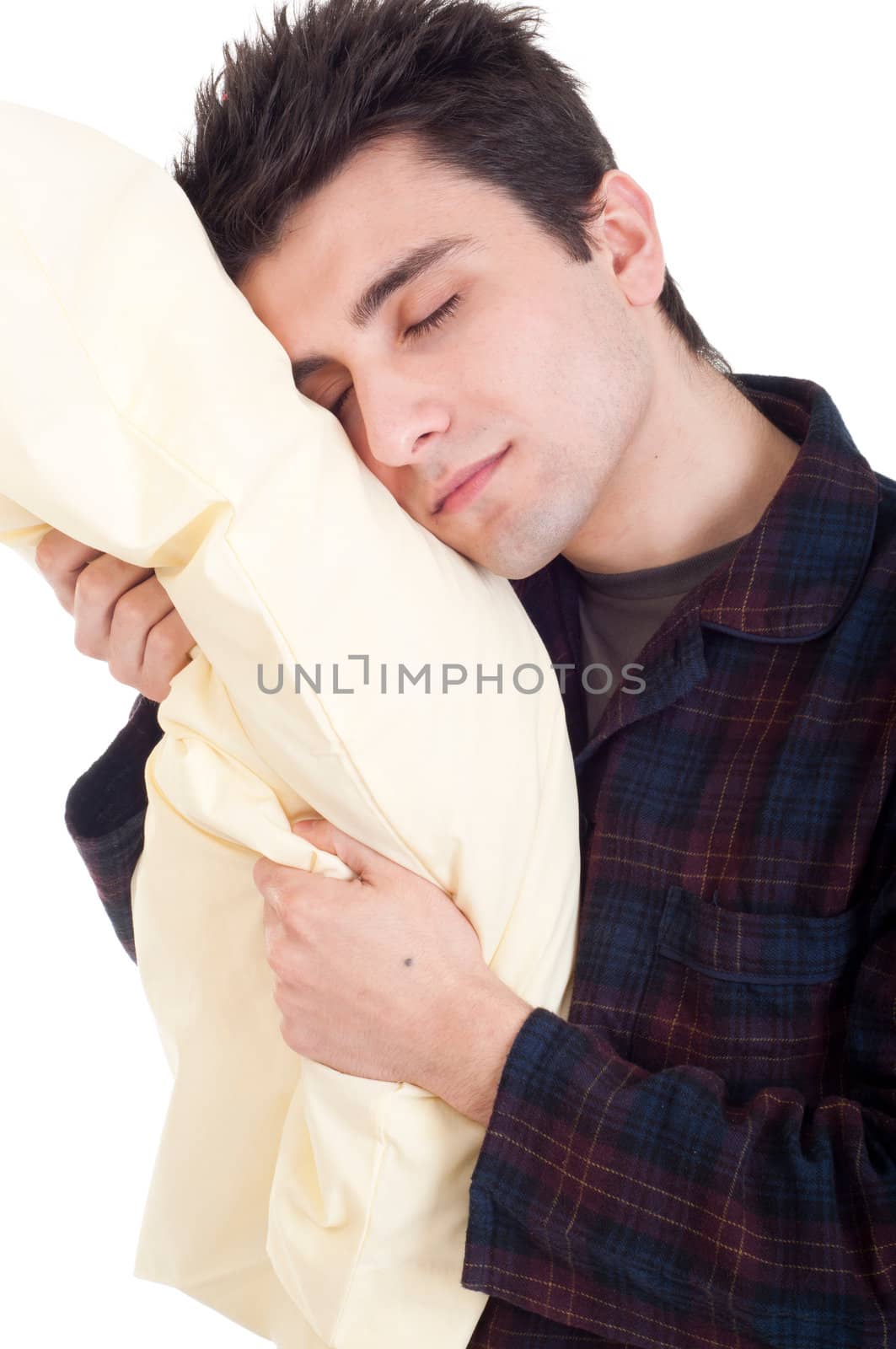 sleepy young man in pajamas holding pillow isolated on white background