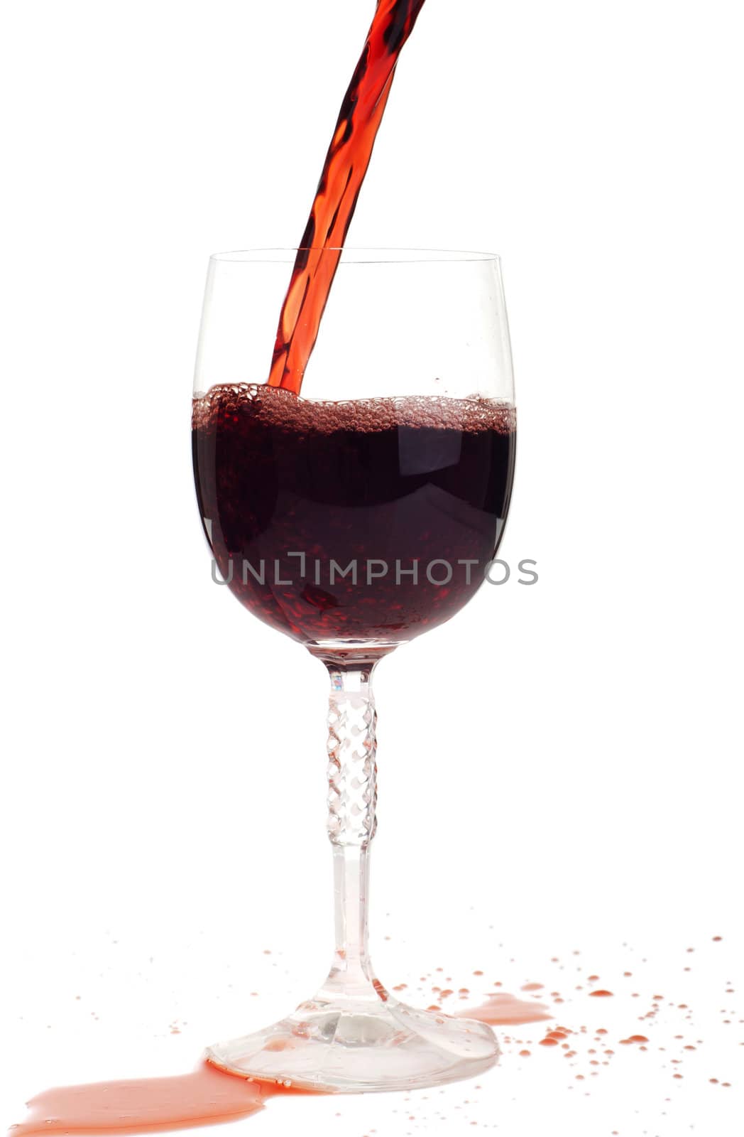 red wine pouring into a crystal glass (isolated on white background)