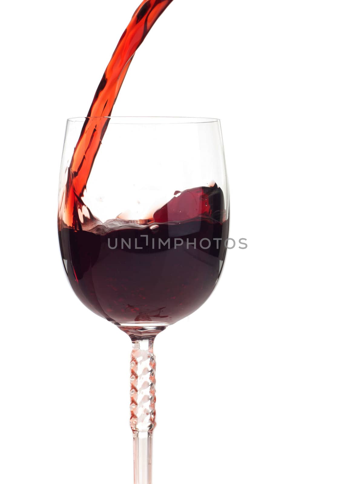 red wine pouring into a crystal glass (isolated on white background)