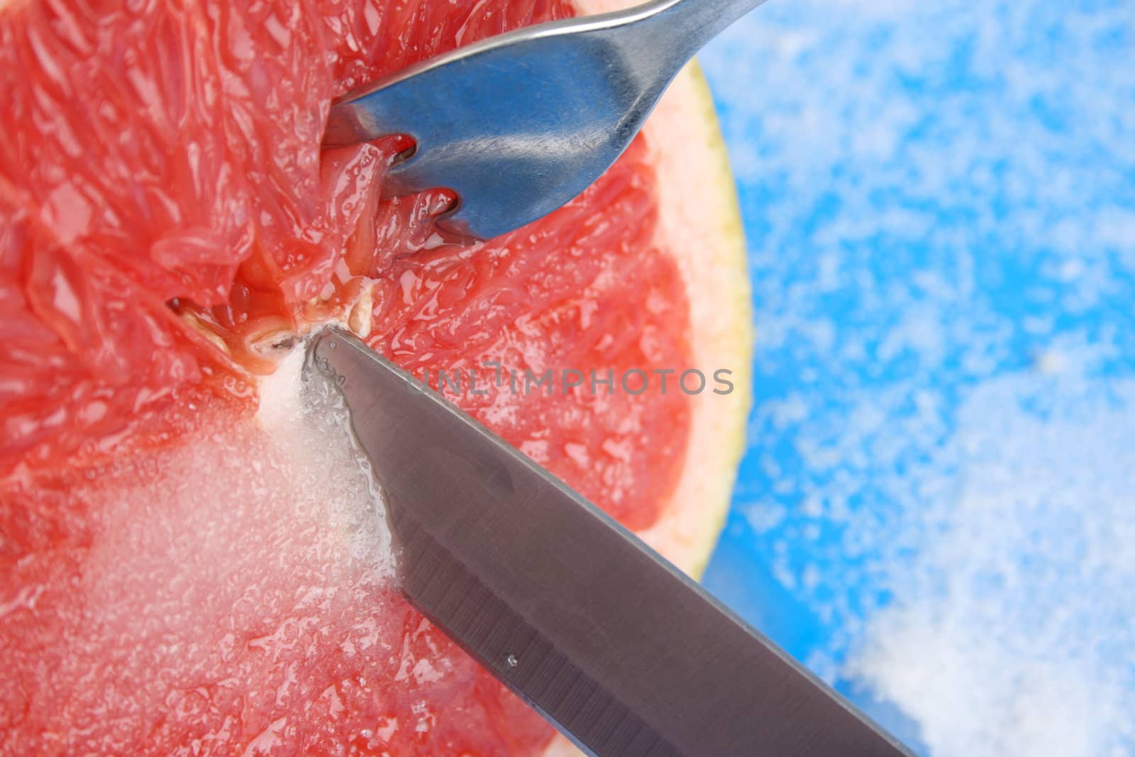 Red Pummelo on a blue background with sugar