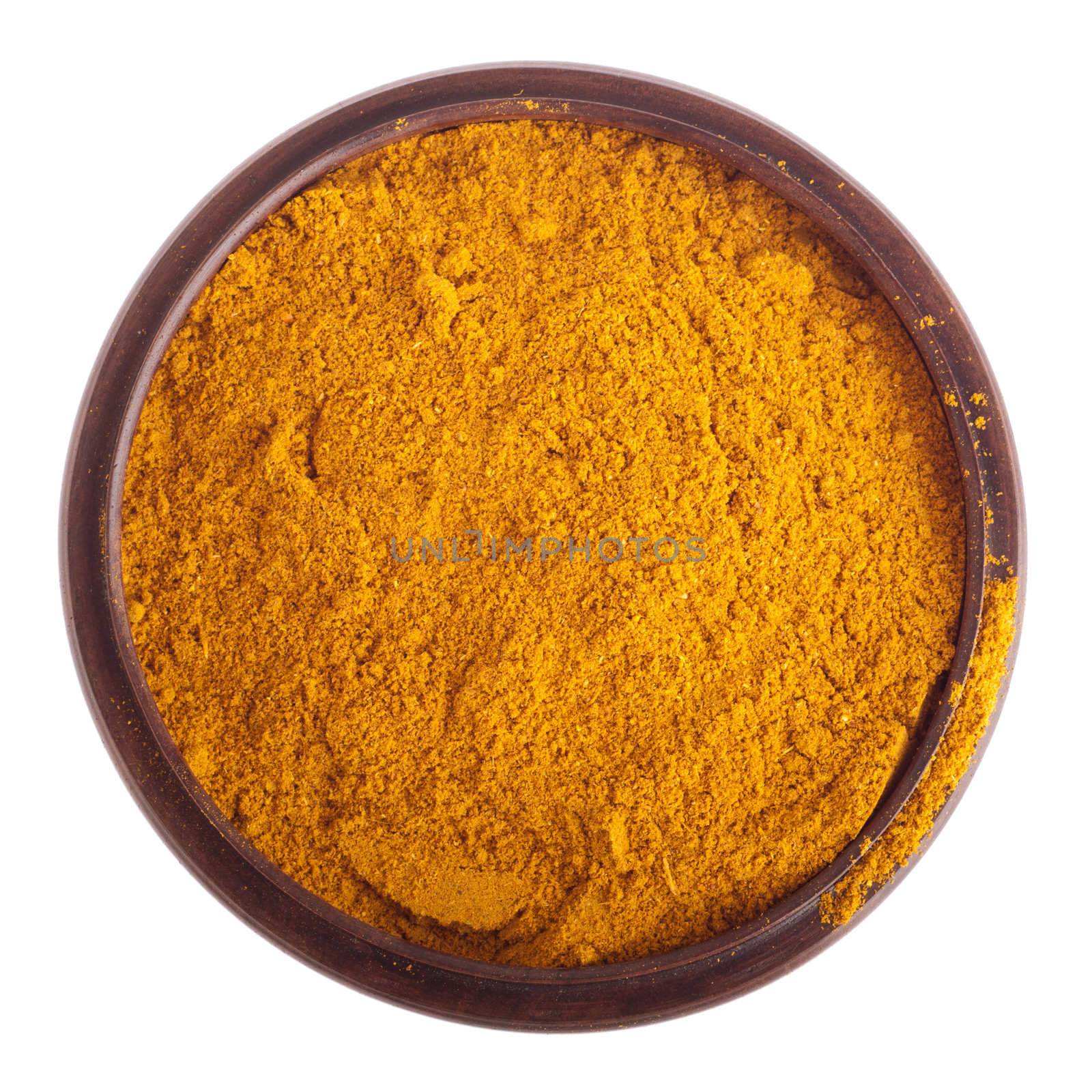 curry powder, mix of indian spices on a vintage wooden bowl (isolated on white background) 