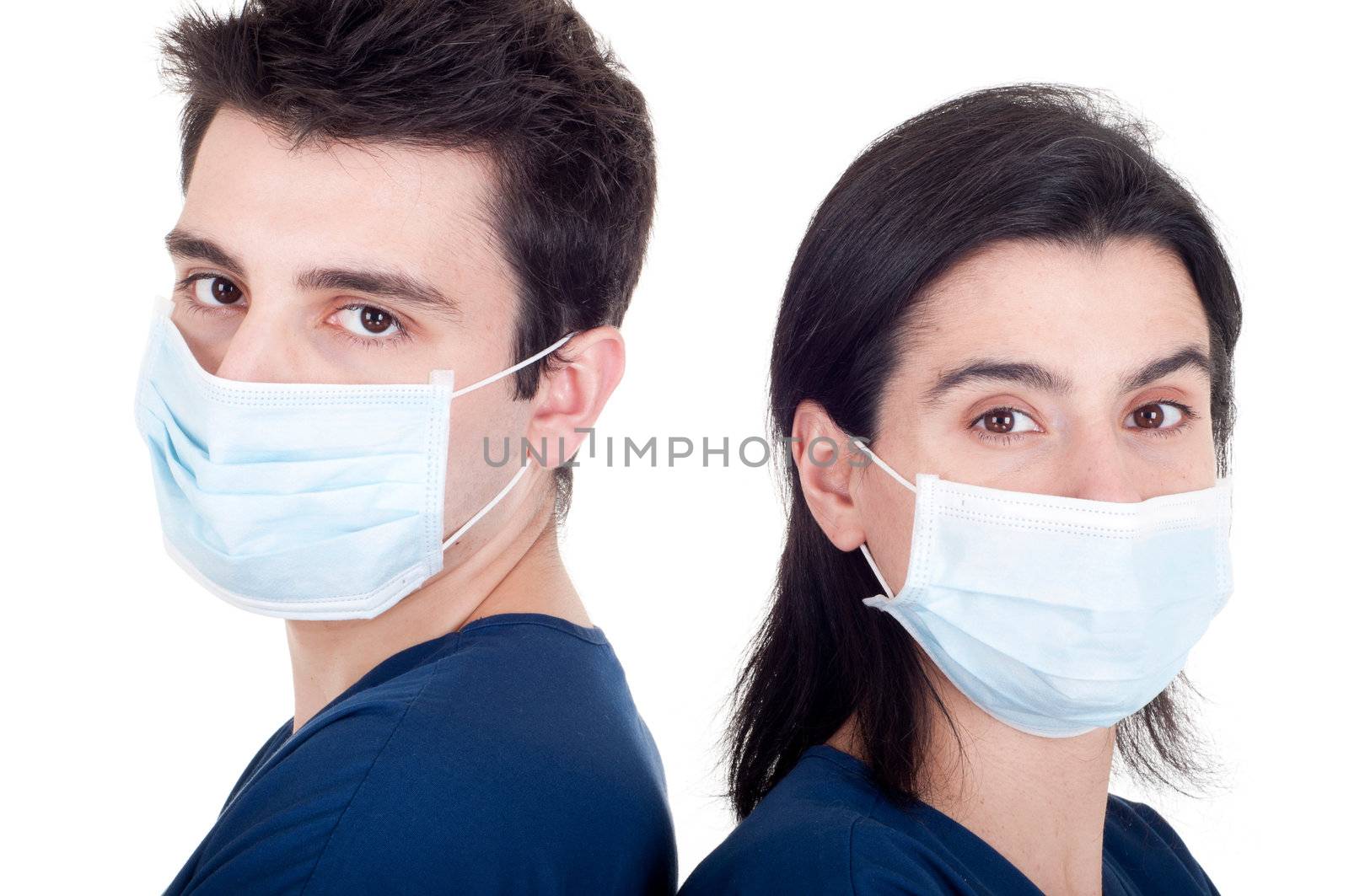 back to back portrait of a team of doctors wearing mask and uniform isolated on white background