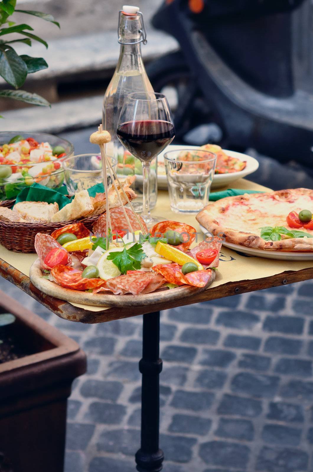 Table with light snack on the street in Italy