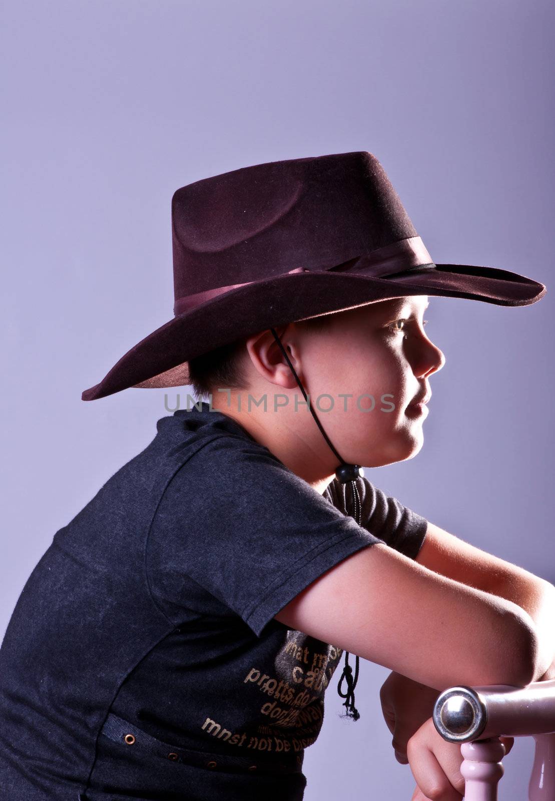 Young boy. Portrait in studio on a grey background.