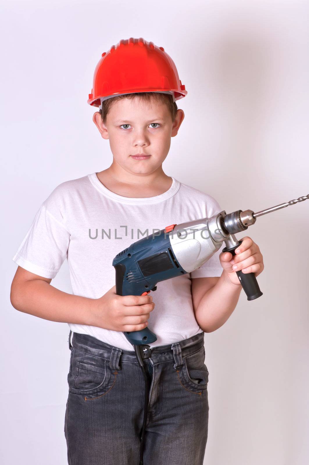 Portrait of a boy in a red protective helmet