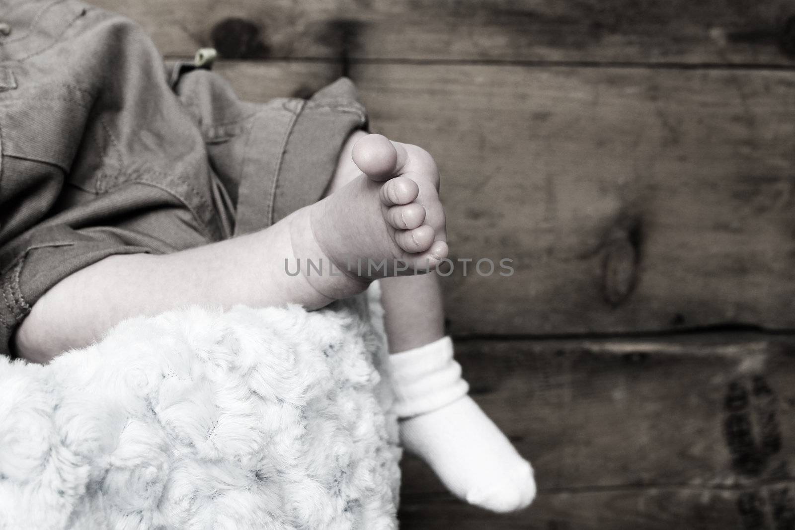 Newborn baby foot with other foot in sock