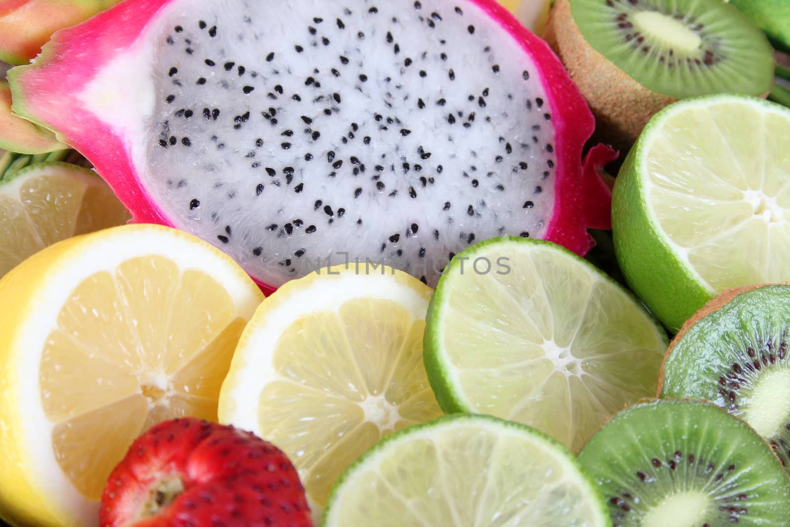 Variety of colorful sliced fruits on a basket