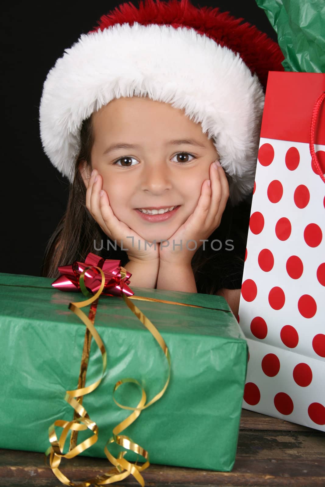 Beautiful little brunette girl dreaming about christmas
