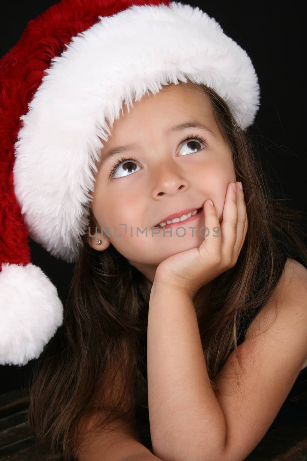 Beautiful little brunette girl dreaming about christmas
