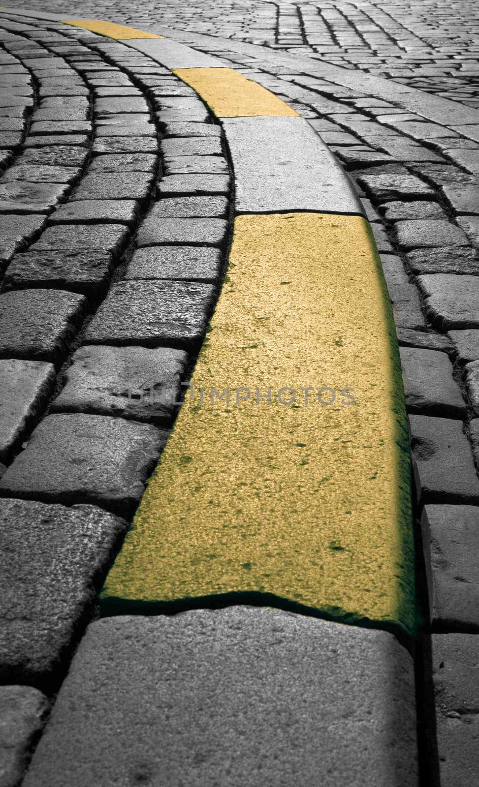 Roadway of cobblestone in Blakc and white and yellow