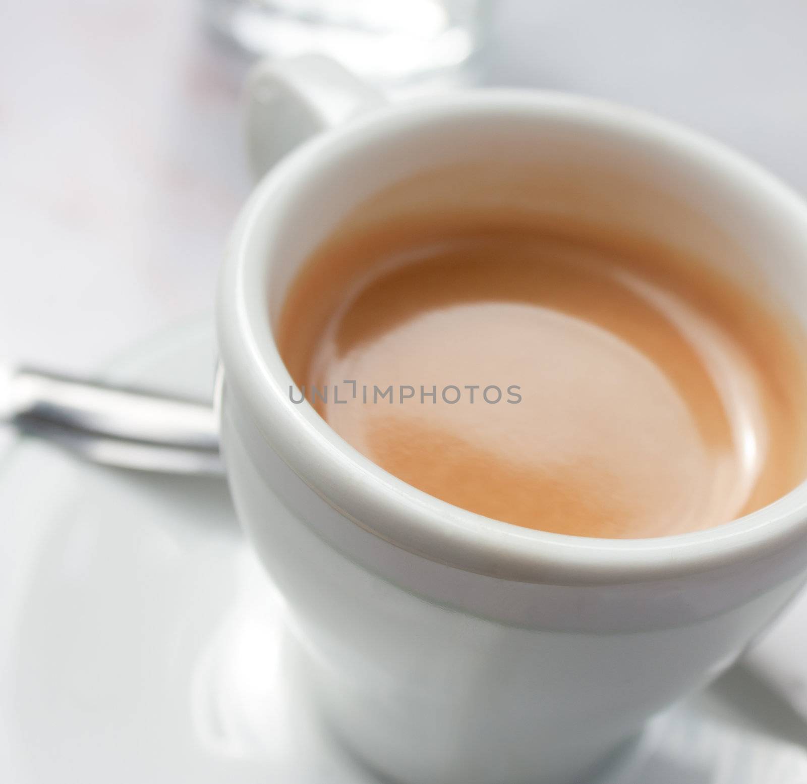 Close-up view of a white cup of coffee, espresso
