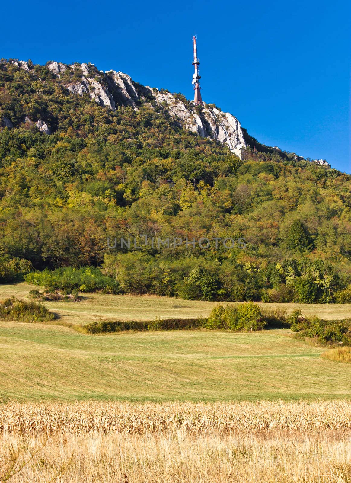 TV tower above beautiful cliffs, forrest & fields on Kalnik mountain, Prigorje county, Croatia - vertical