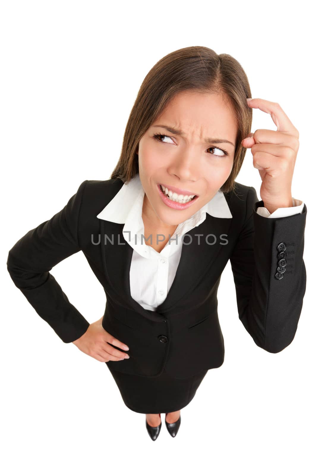 Thinking people. Business woman wondering funny looking to side pondering something while scratching her head. High angle view of mixed race Caucasian / Chinese Asian businesswoman isolated on white background.